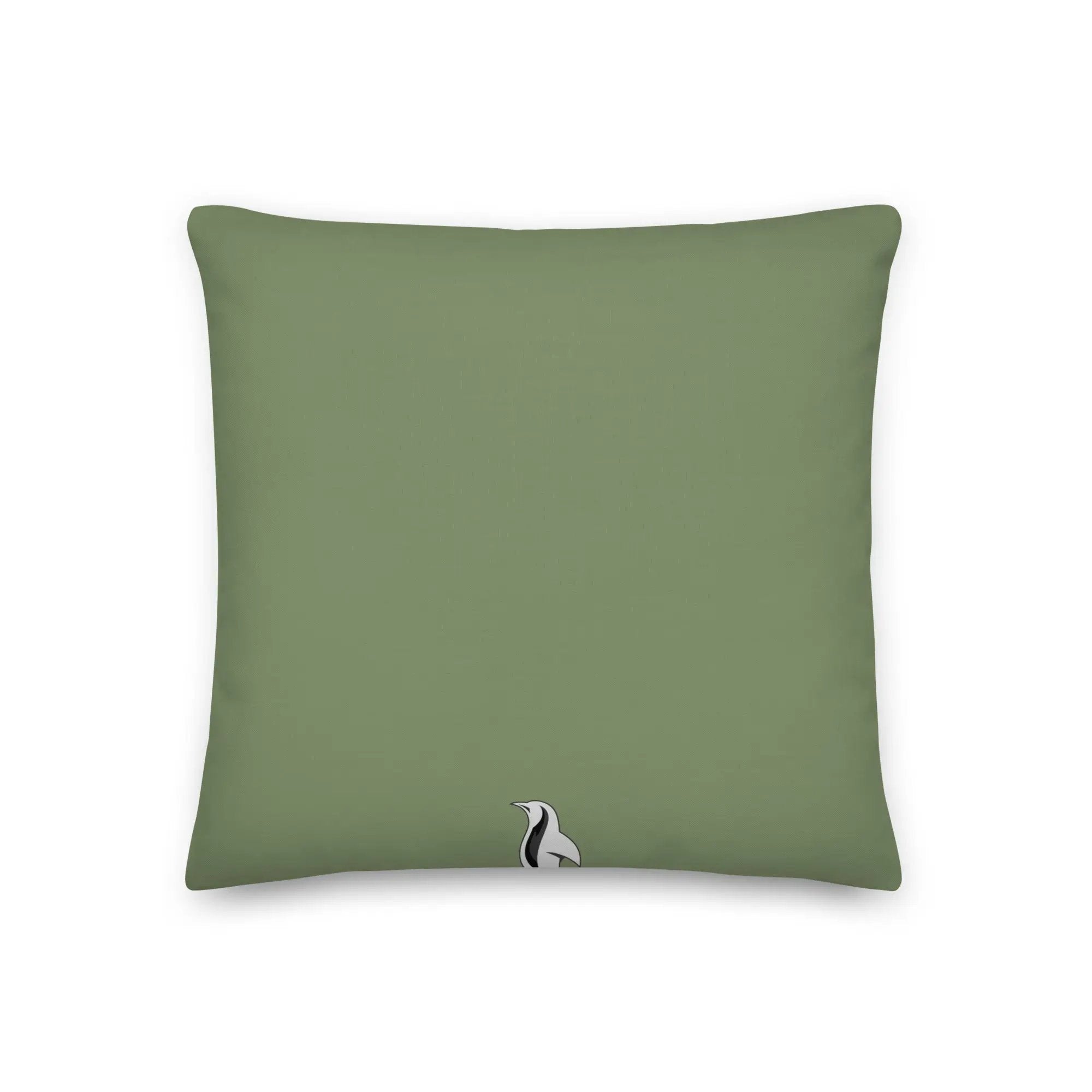 a green pillow with a black and white bird on it