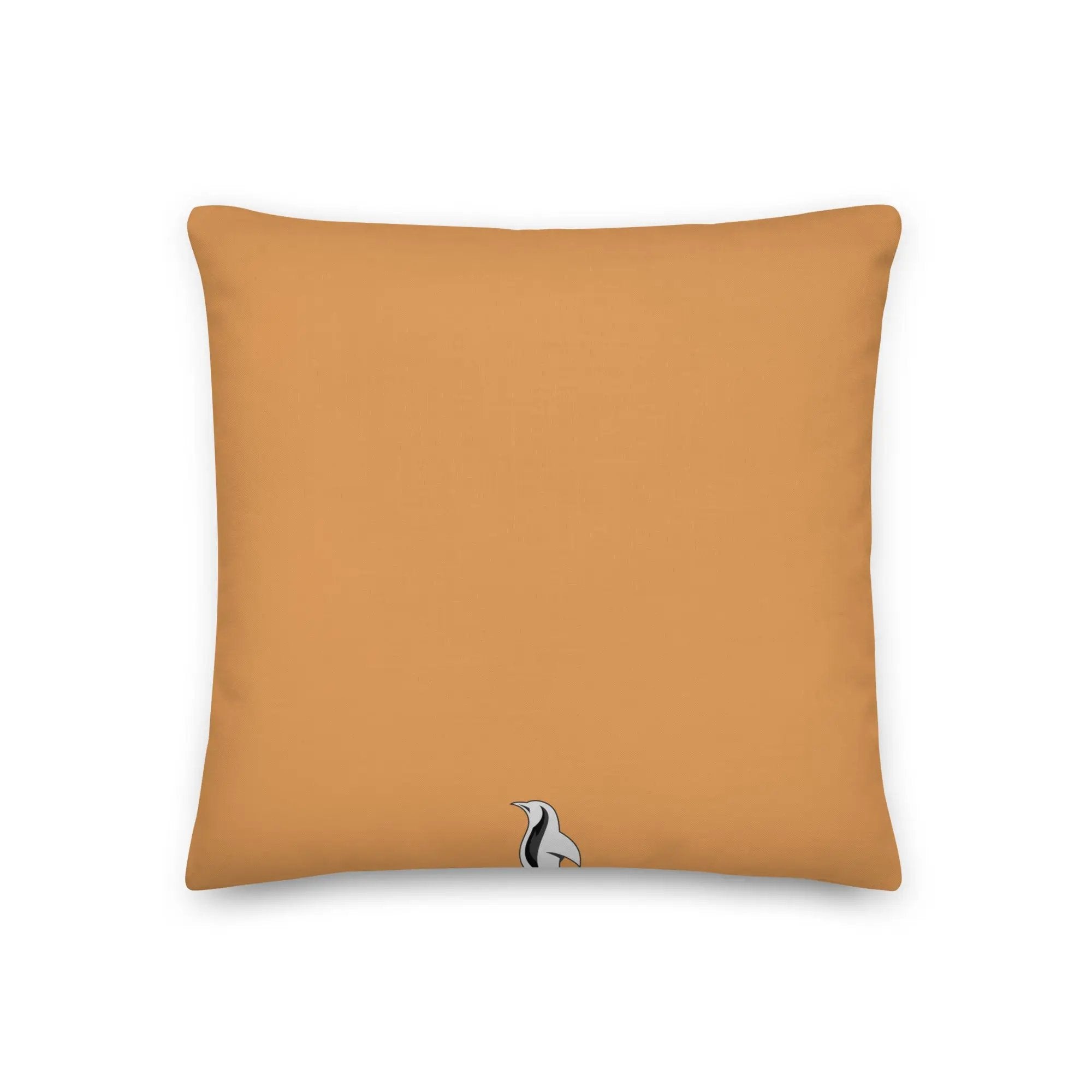 an orange pillow with a black and white cat on it