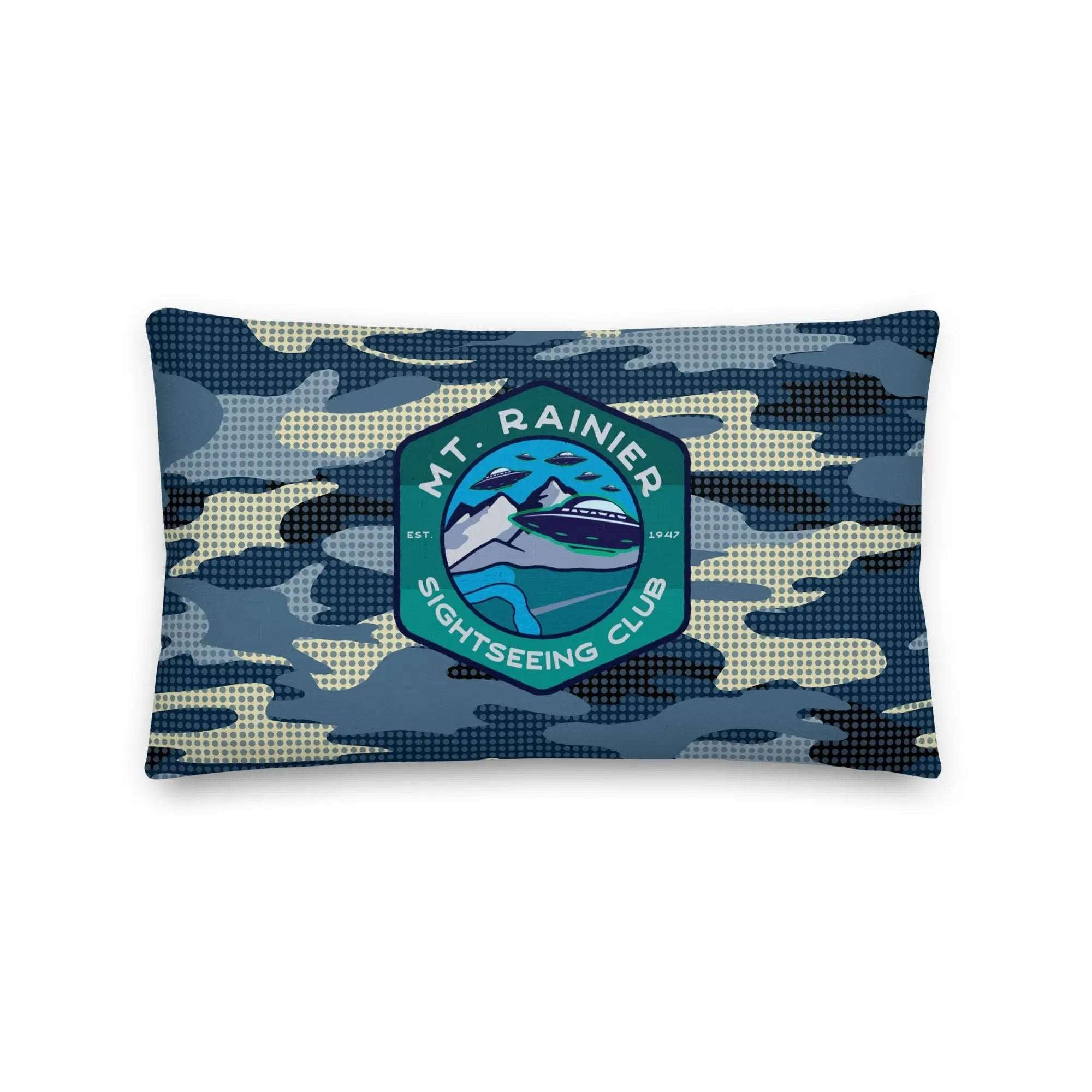 a blue camo pillow with a mountain badge on it