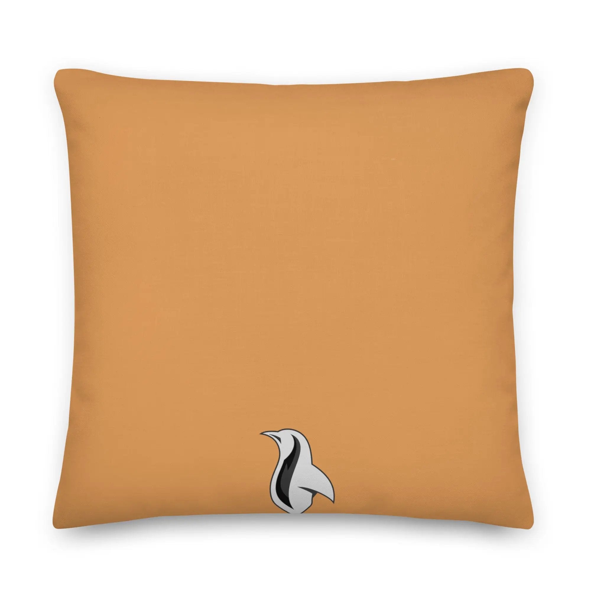 an orange pillow with a black and white bird on it
