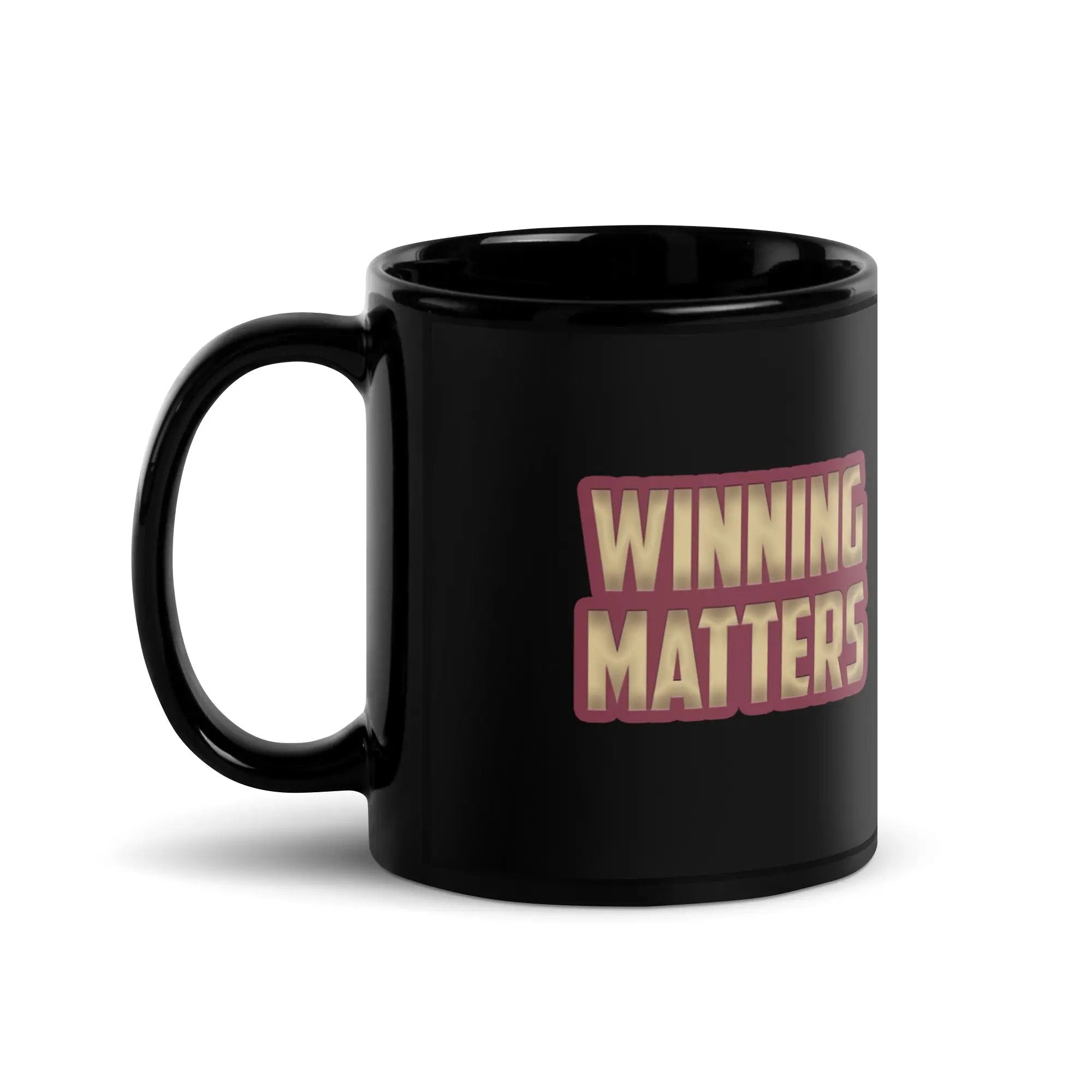 a black coffee mug with the words winning matters on it