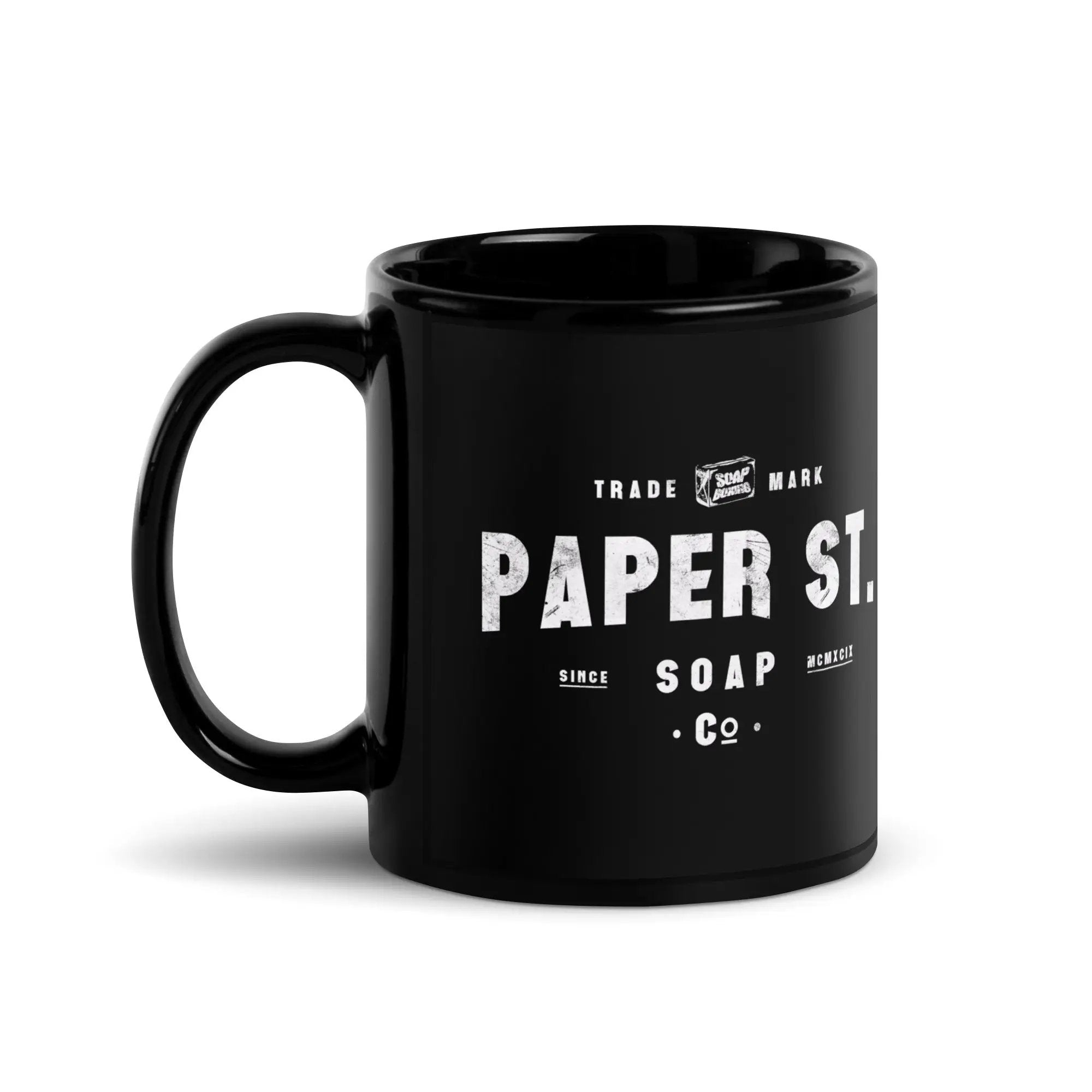a black coffee mug with the words paper st on it