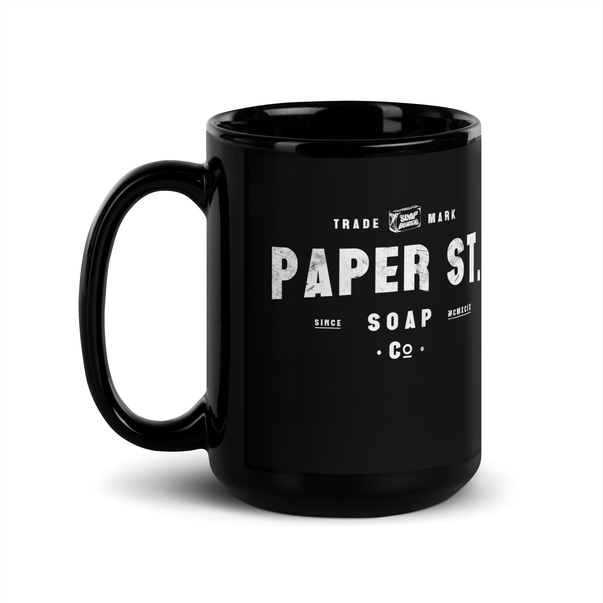 a black coffee mug with the words paper st on it