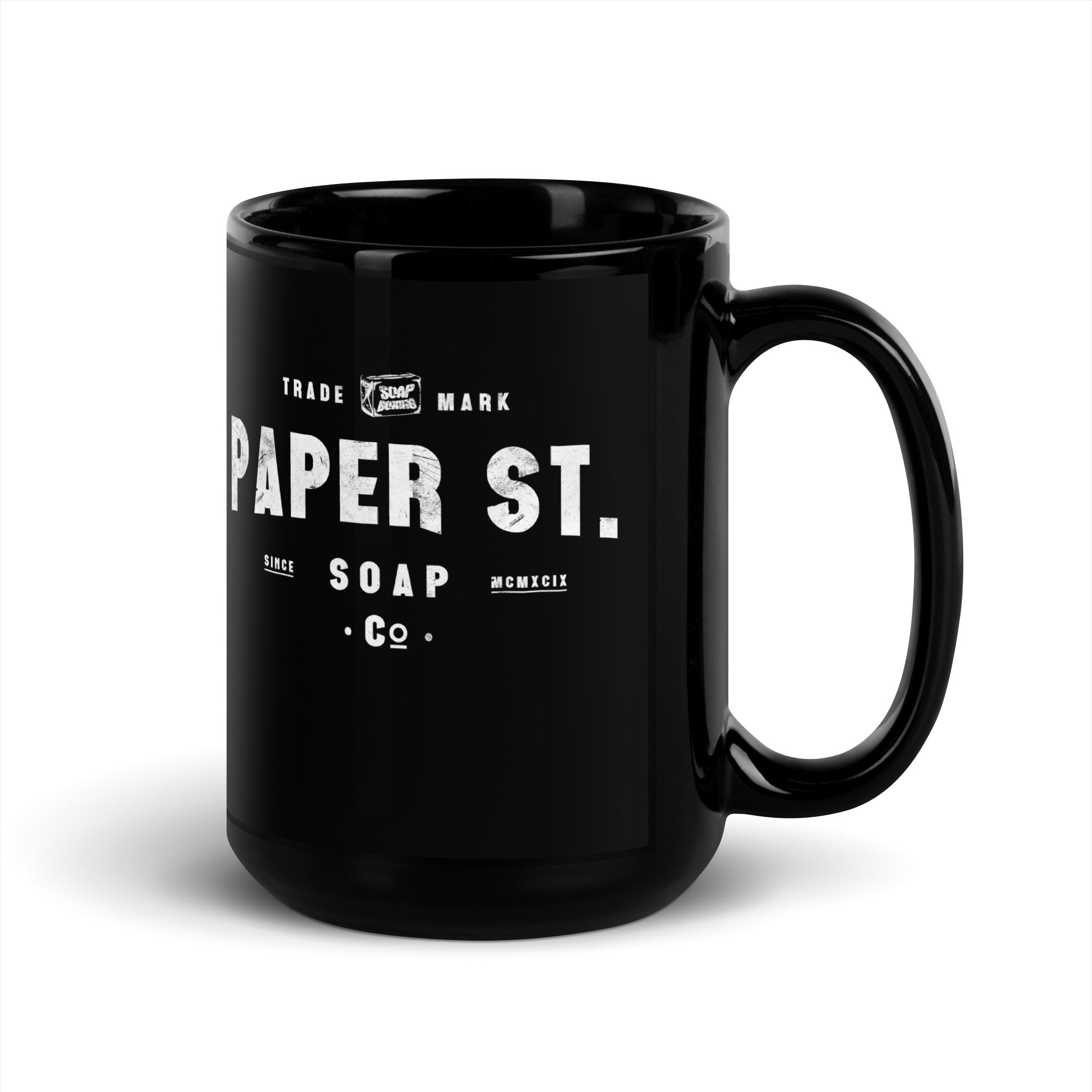 a black coffee mug with the words paper st on it