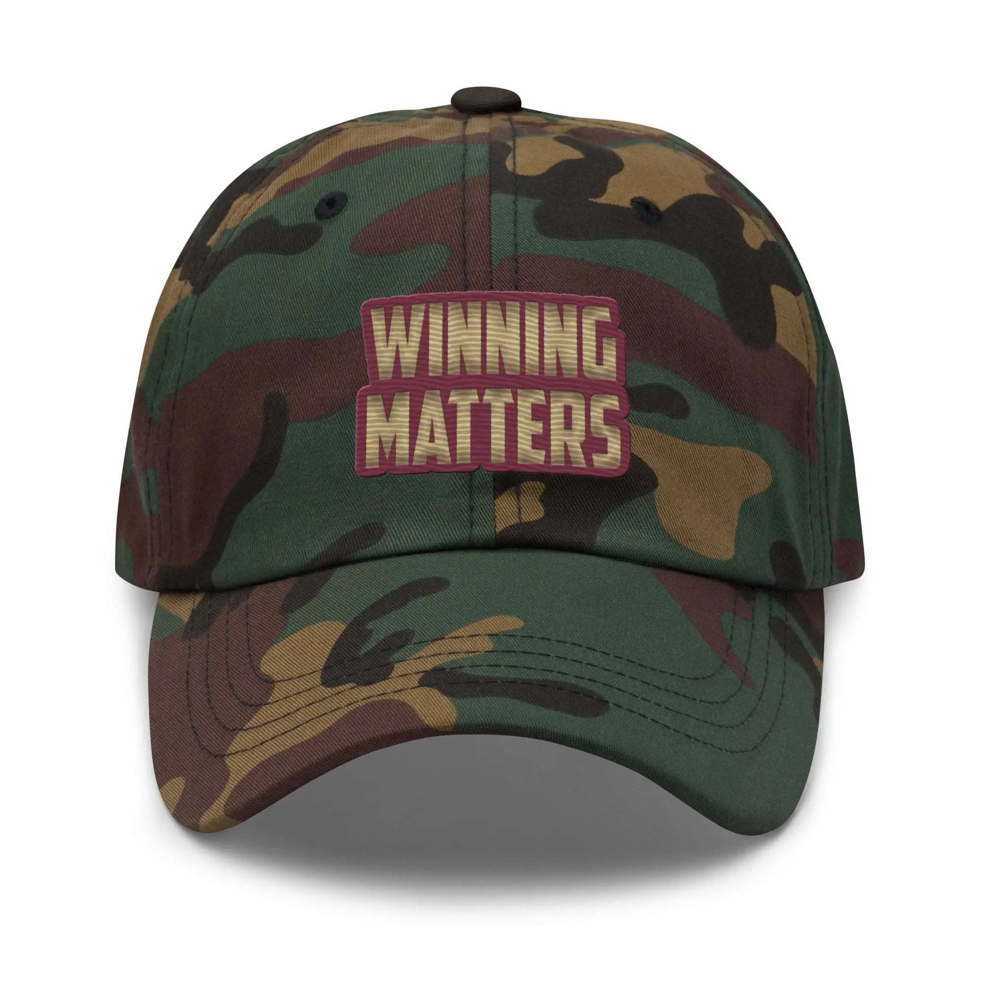 a green and brown hat with the words winning matters on it