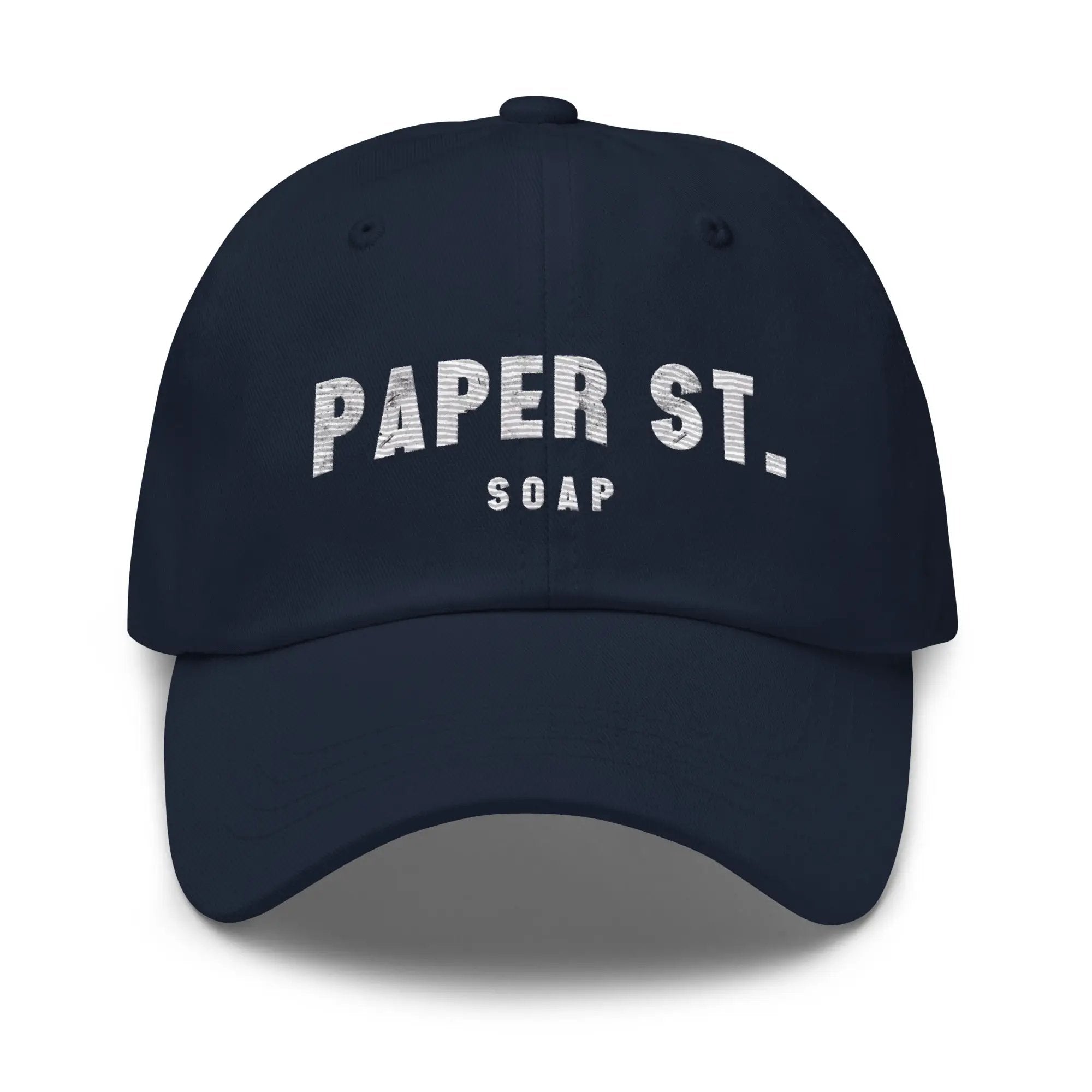 a navy baseball cap with the word paper st soap printed on it