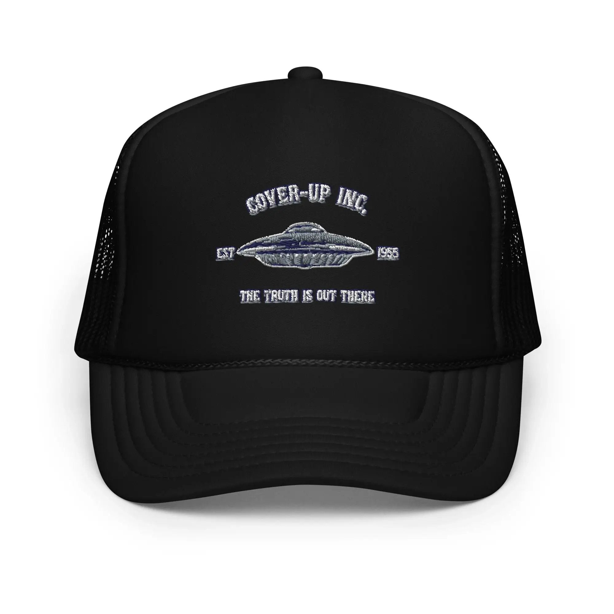 a black trucker hat with an image of a flying saucer