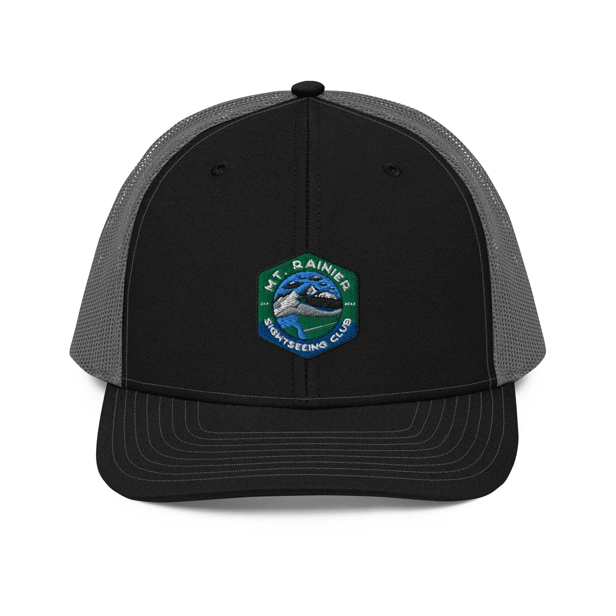 a black and gray hat with a green and white patch