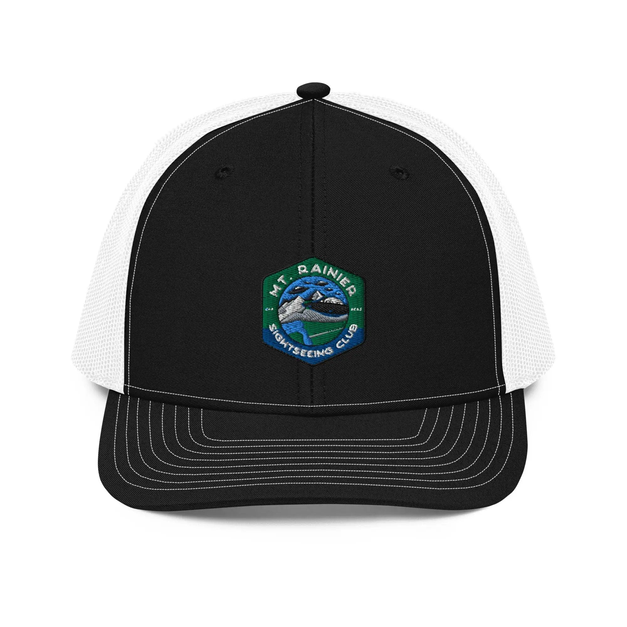 a black and white trucker hat with a green and white patch on the front
