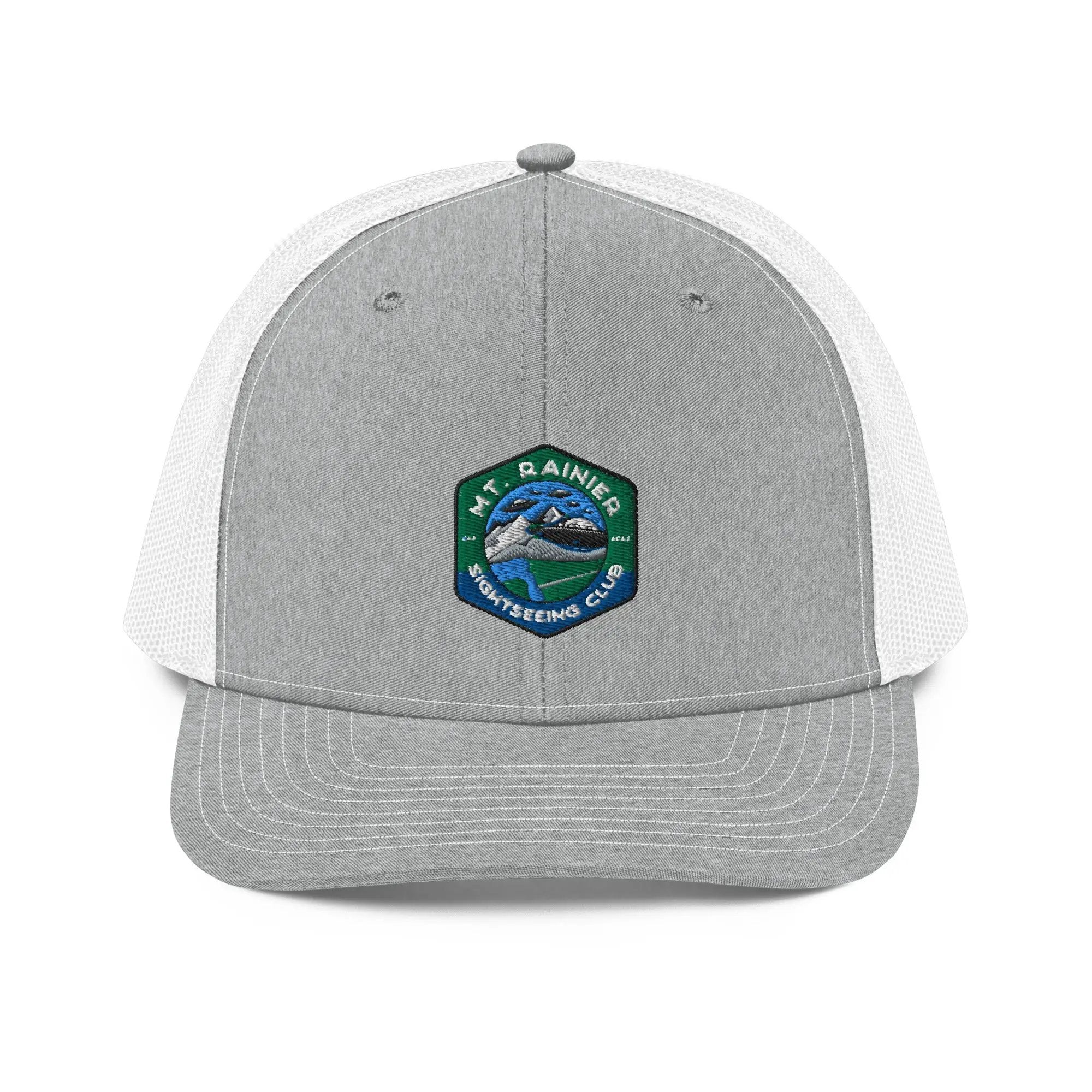 a gray and white trucker hat with a green and white patch on the front