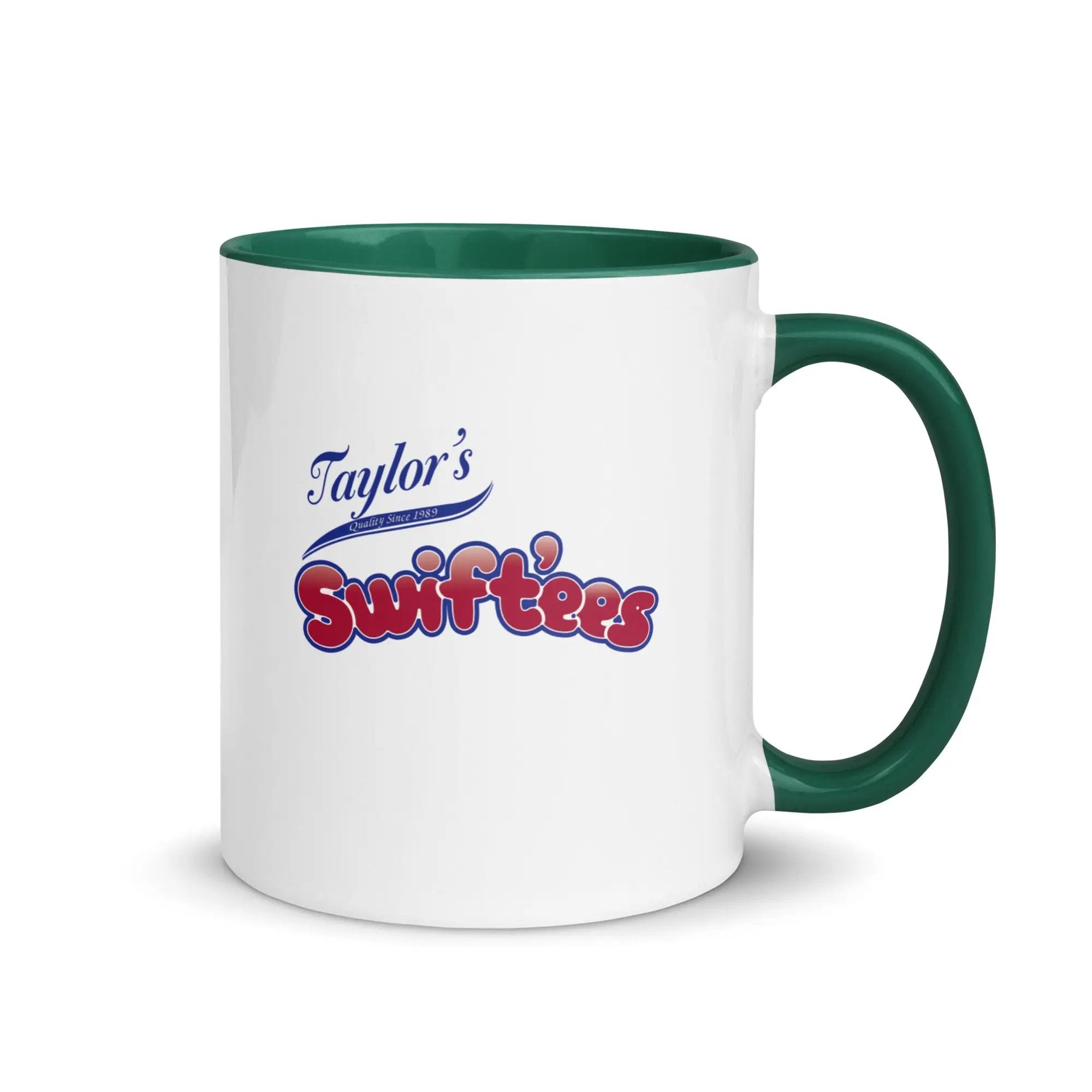 a white and green coffee mug with taylor's swiftfeasts on it