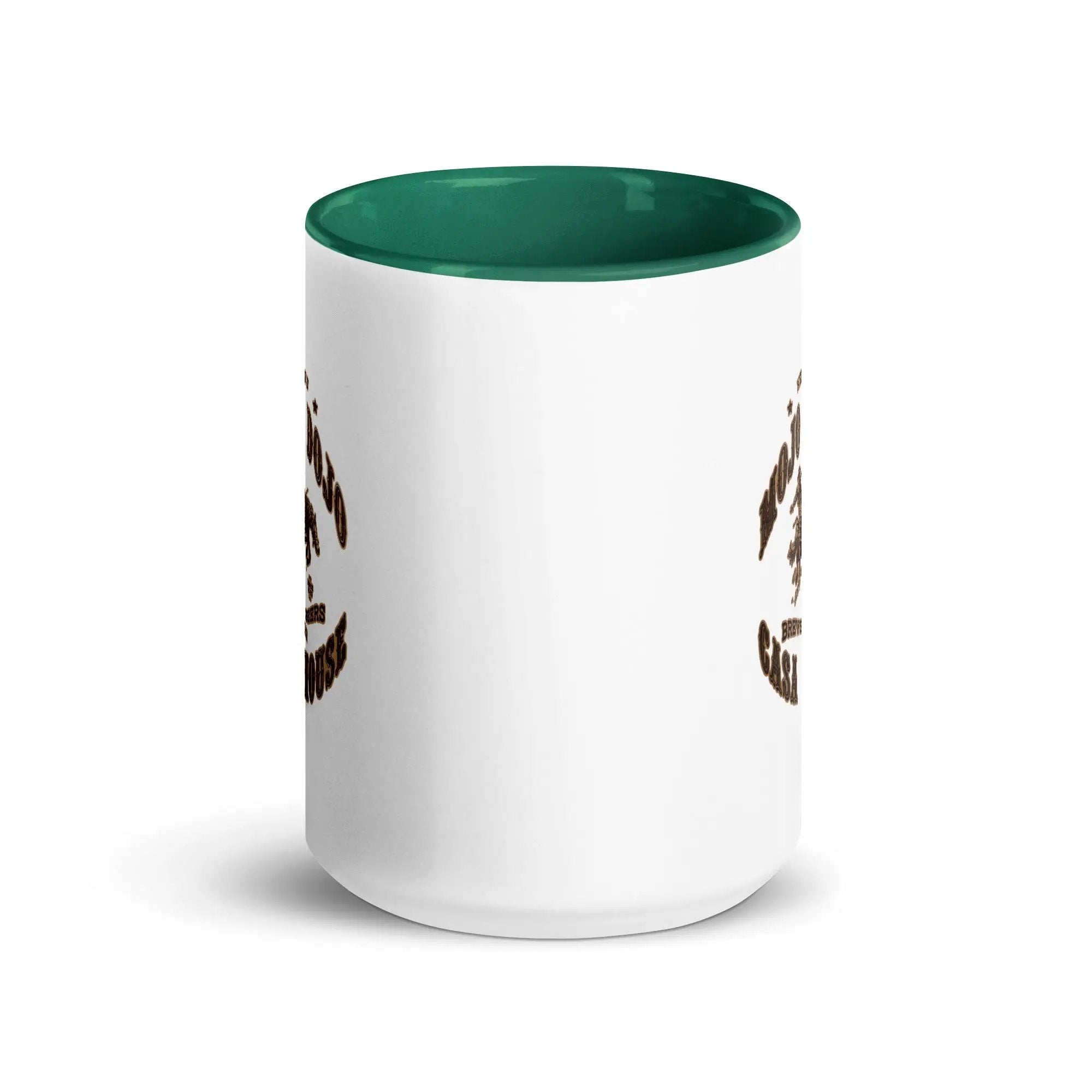 a white and green coffee mug with an owl on it