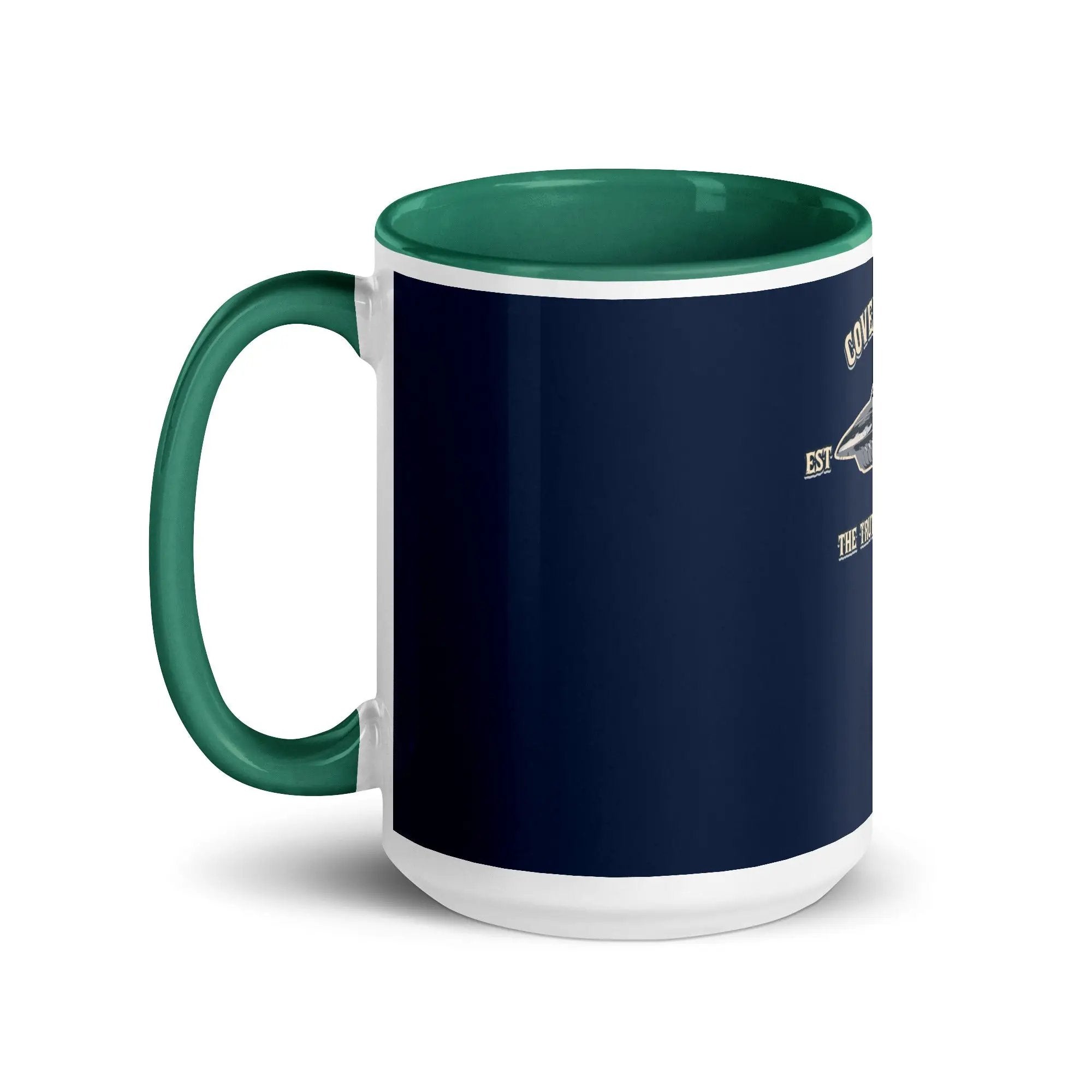 a blue and white coffee mug with a green handle