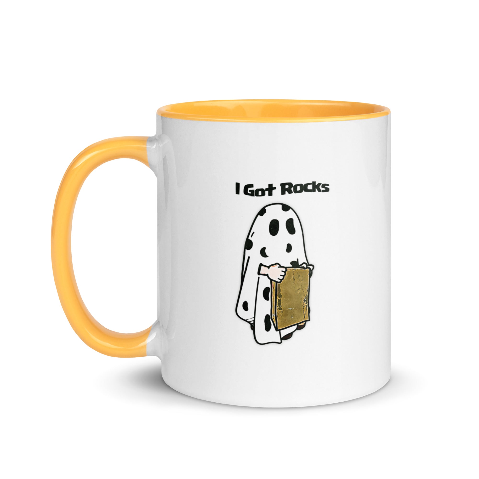 a white and yellow coffee mug with a cartoon of a ghost holding a piece of