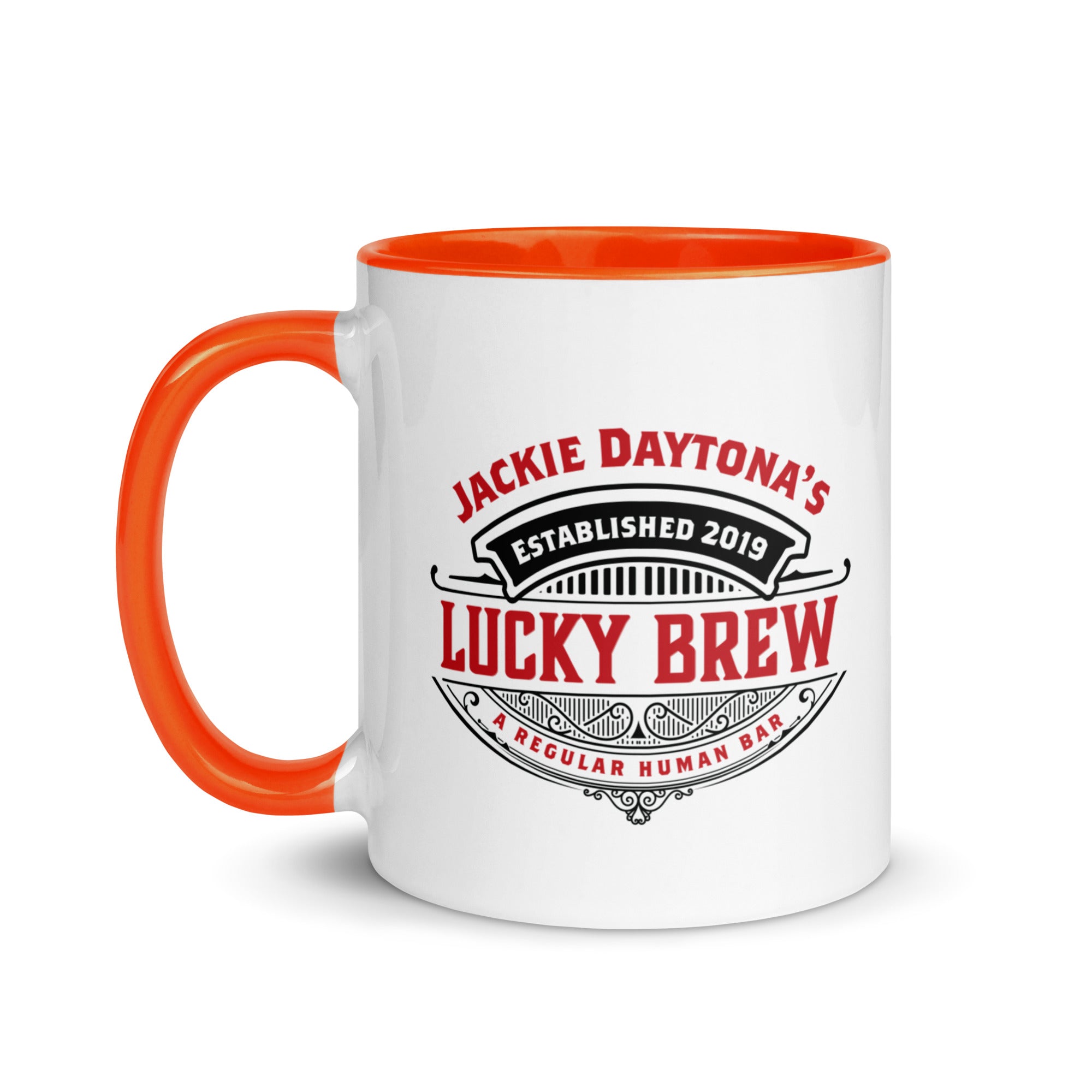 a white and orange coffee mug with an orange handle