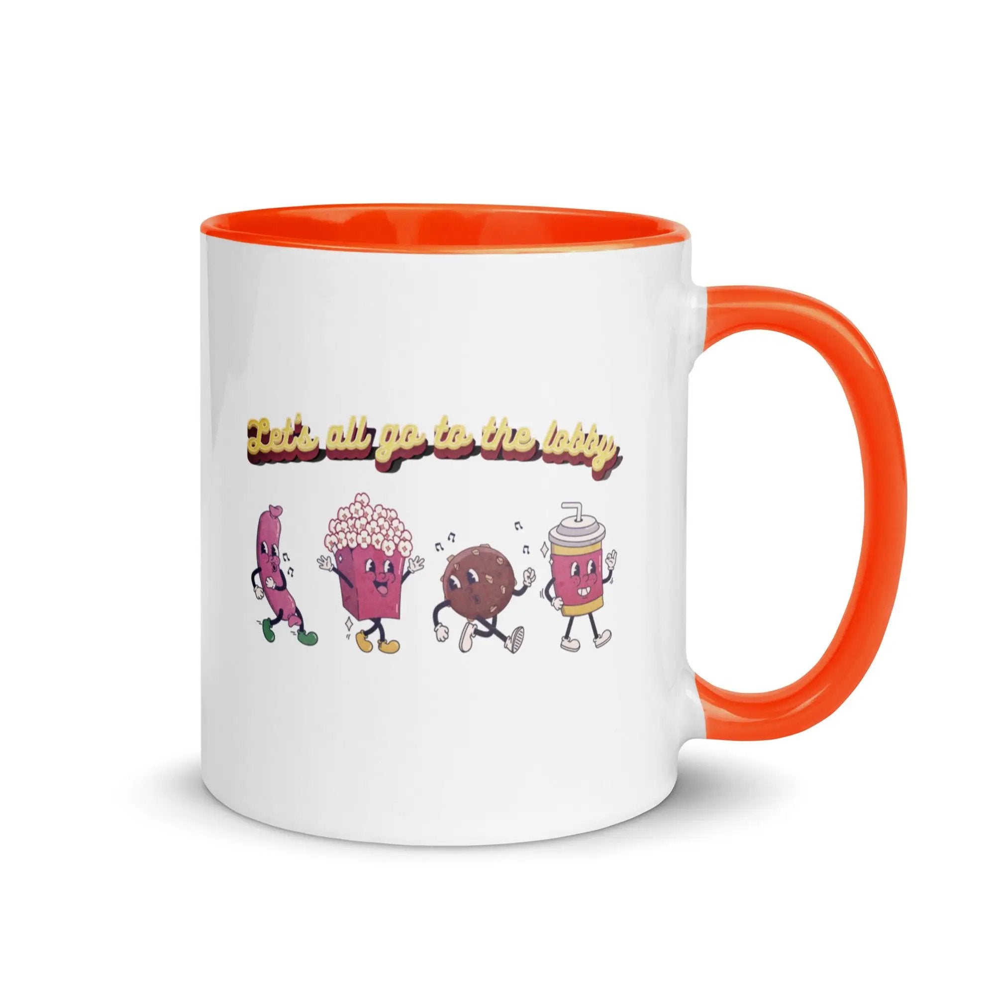 a white and orange coffee mug with an orange handle