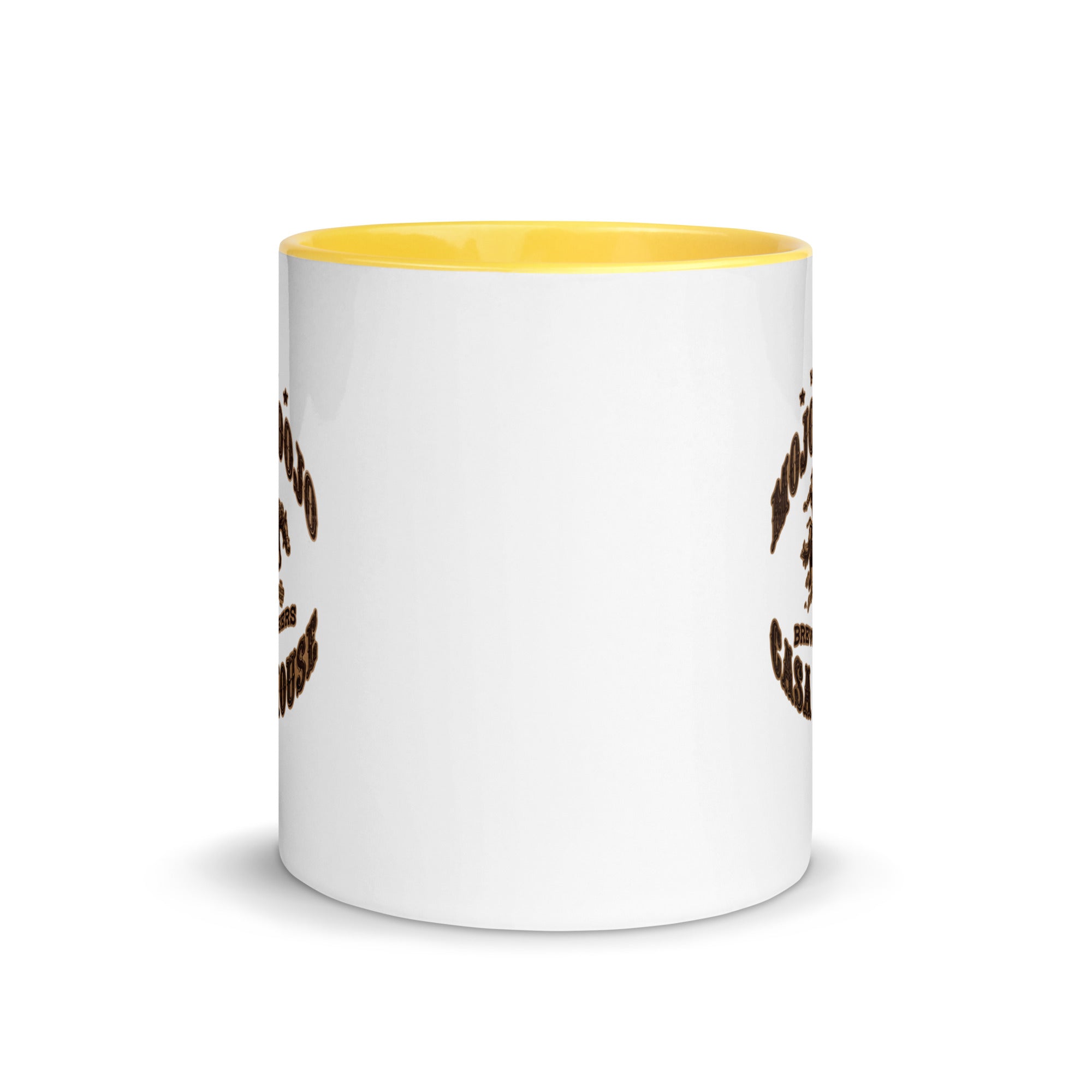 a white and yellow coffee mug with a brown and white design