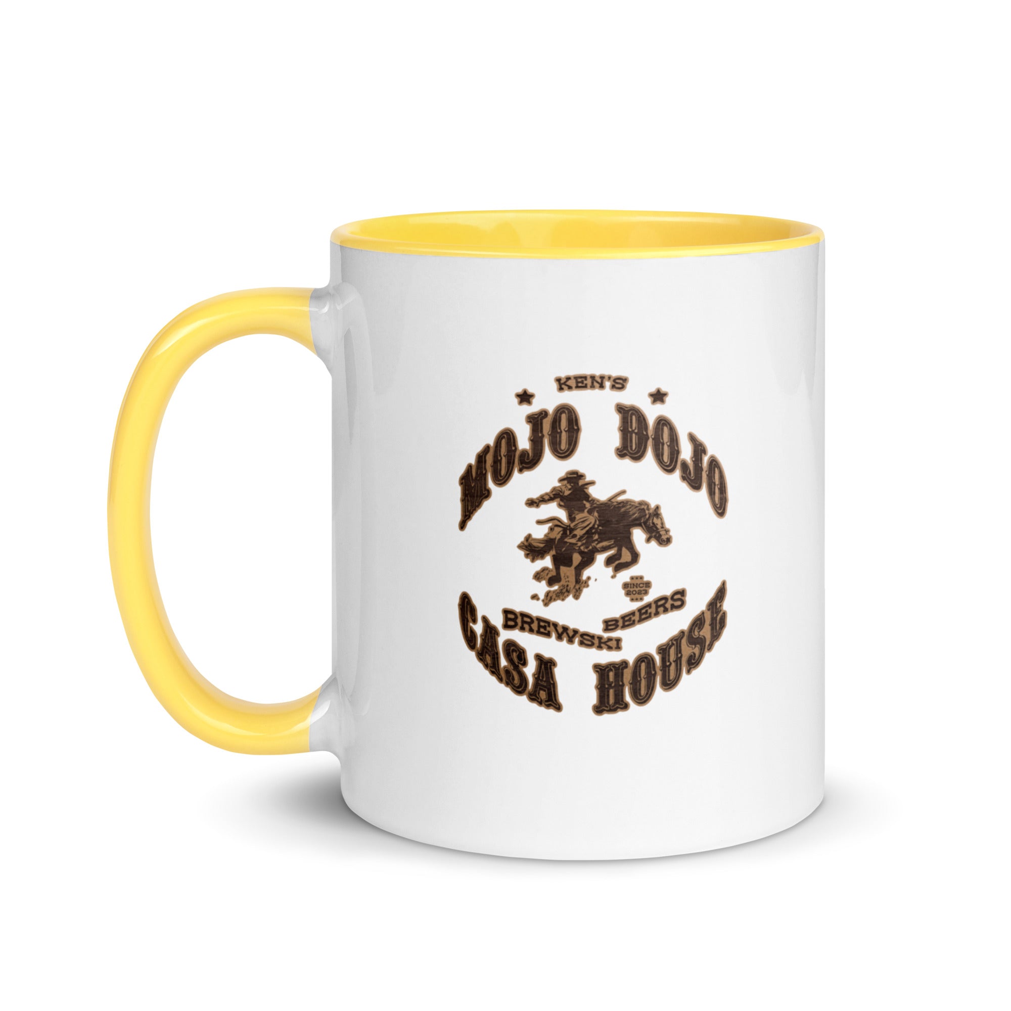 a white and yellow coffee mug with the words old dog saloon on it