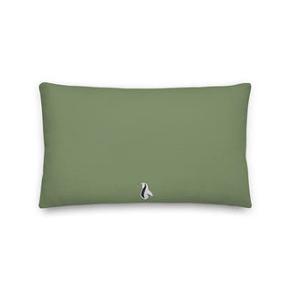 a green pillow with a white bird on it