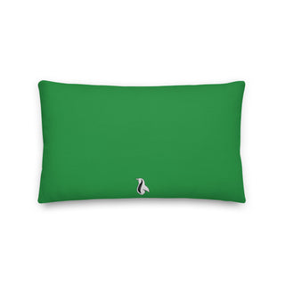 a green rectangular pillow with a black and white penguin on it
