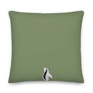 a green pillow with a black and white bird on it