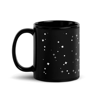 a black coffee mug with white stars on it