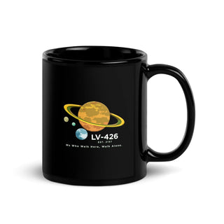 a black mug with a picture of the planets on it