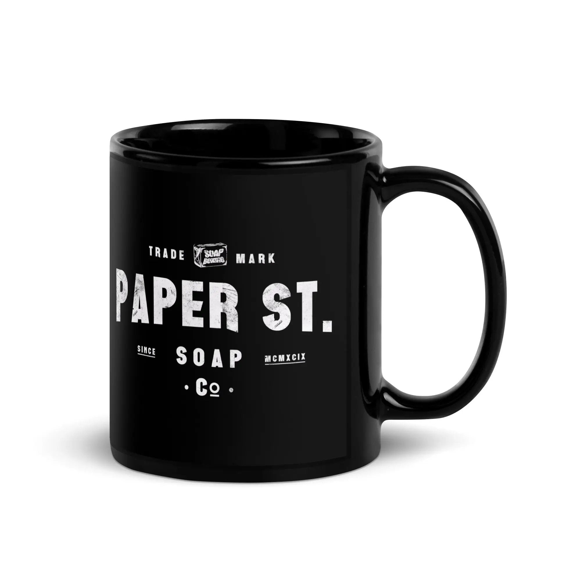 a black coffee mug with the words paper st on it