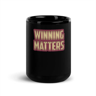 a black coffee mug with the words winning matters on it