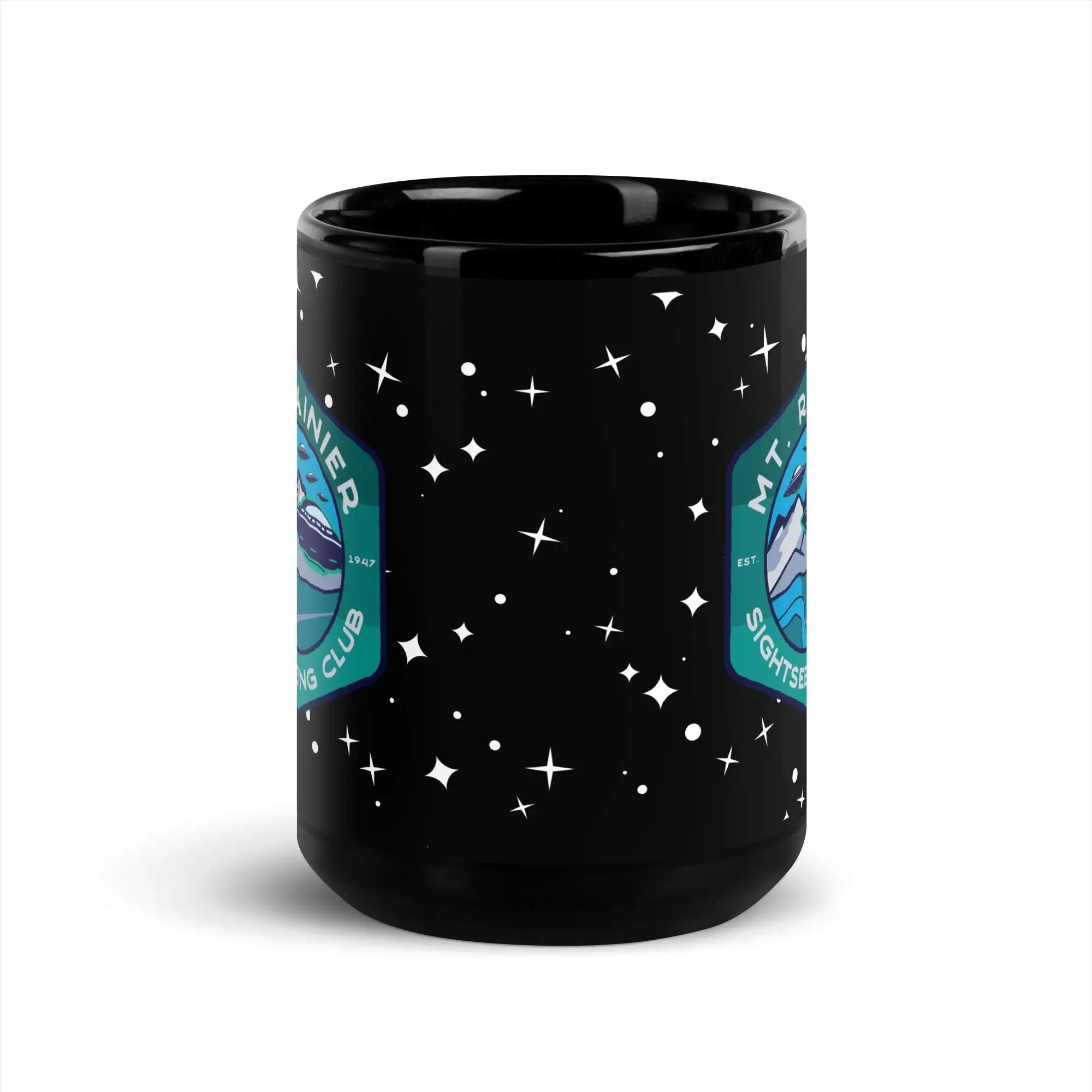 a black coffee mug with a mountain and stars on it