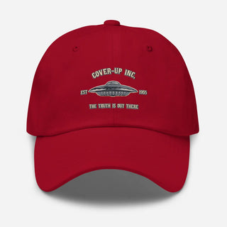 a red hat with the words cover up inc on it