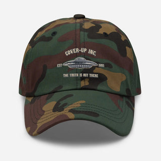 a camo hat with the words cover up inc on it