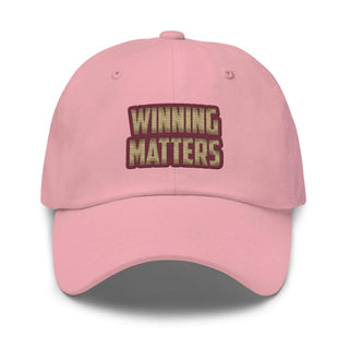 a pink hat with the words winning matters on it