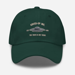 a green hat with the words cover up inc on it