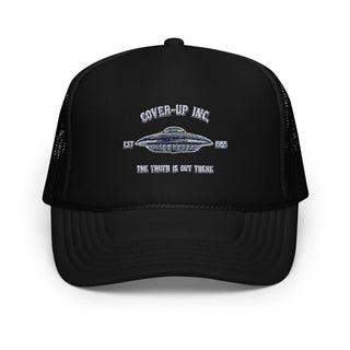 a black trucker hat with an image of a flying saucer