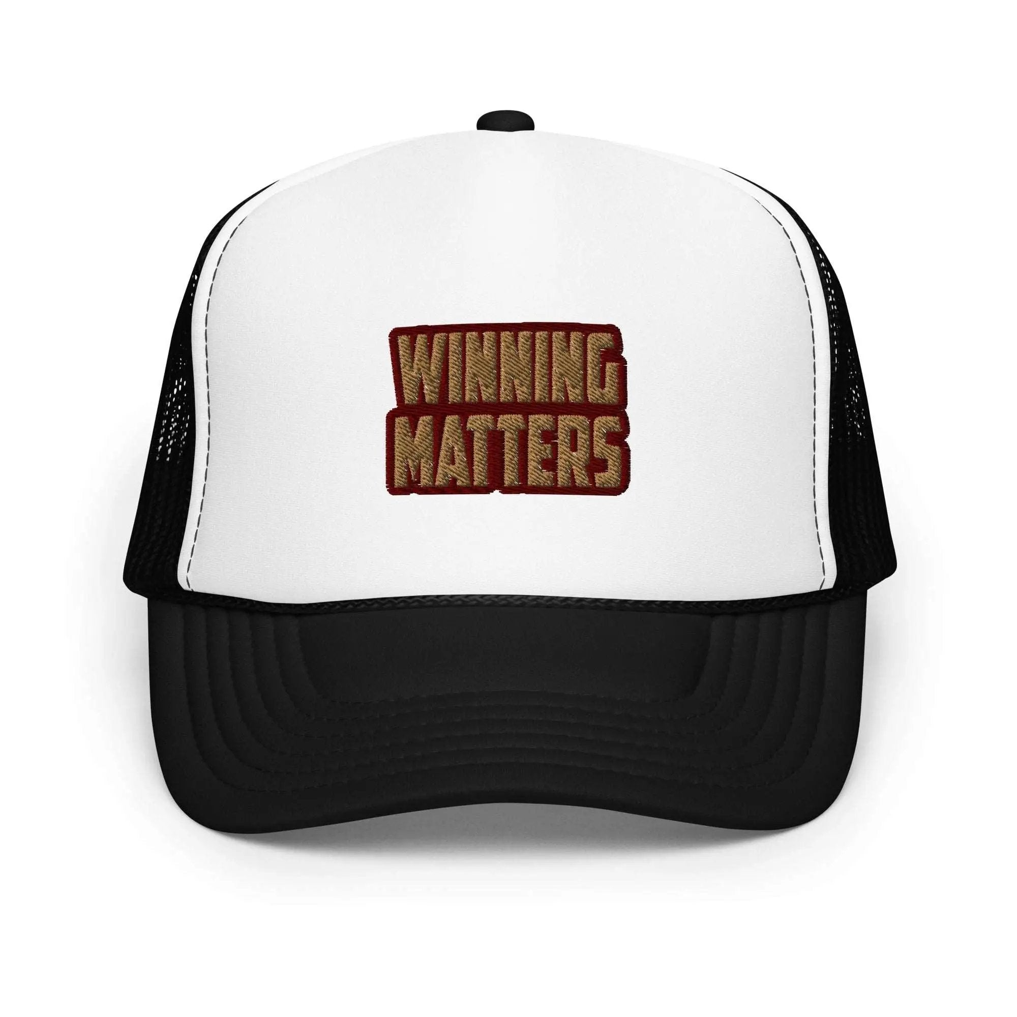 a white and black trucker hat with the words winning matters printed on it