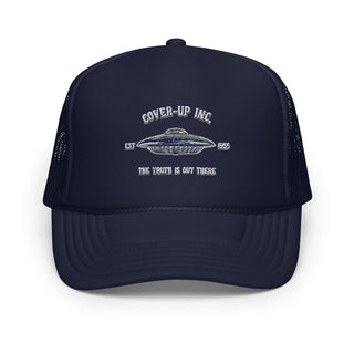 a navy trucker hat with an image of a flying saucer