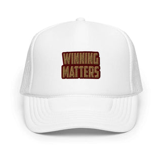 a white trucker hat with the words winning matters printed on it