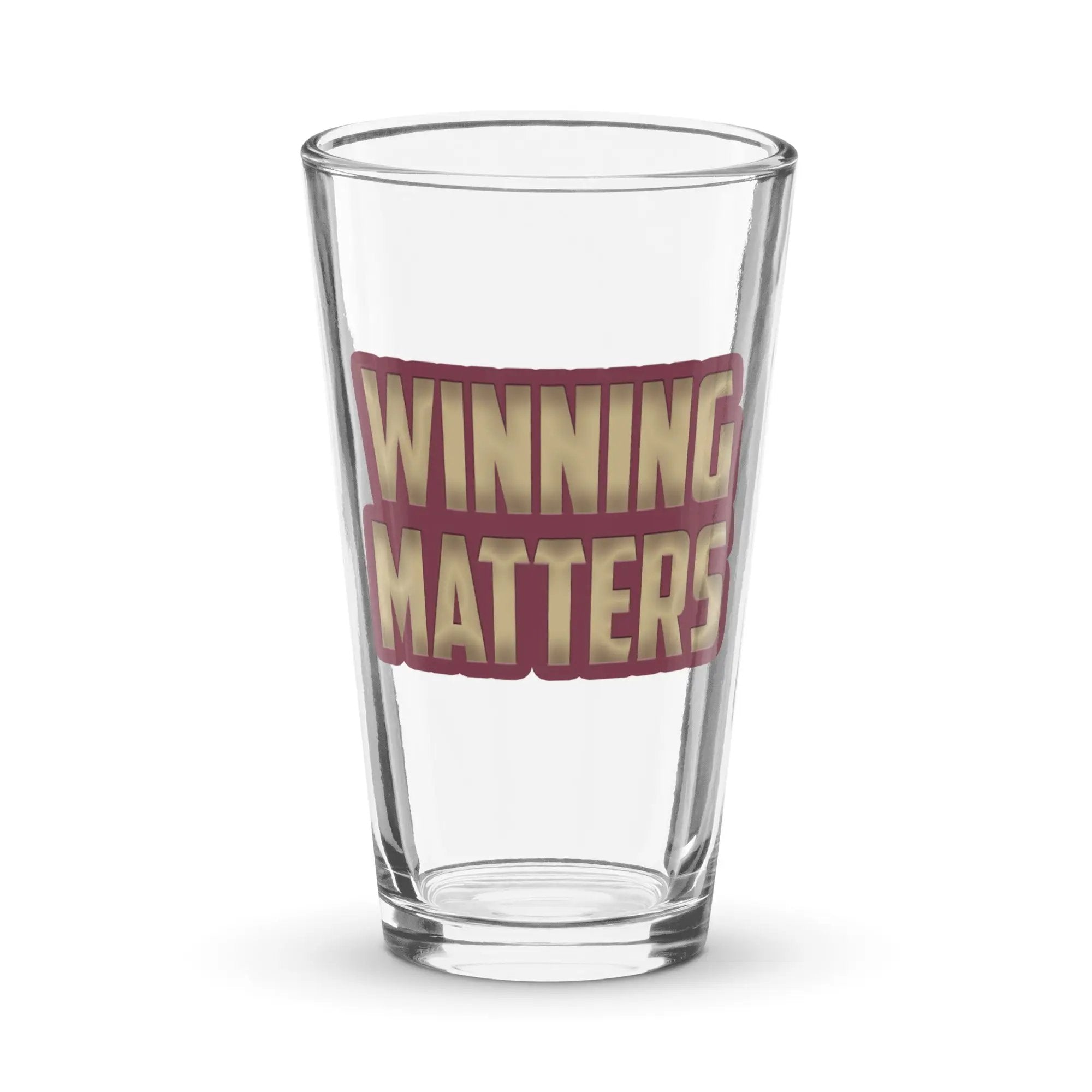 a shot glass with the words winning matters printed on it