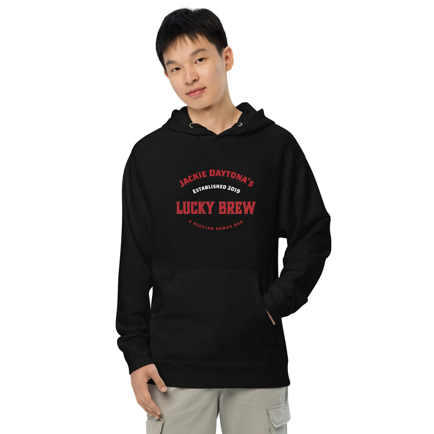 a man wearing a black hoodie with the words lucky brew on it