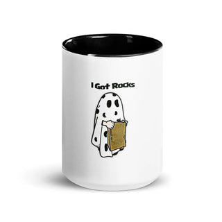 a white and black coffee mug with a ghost holding a book