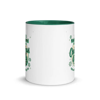 a white and green coffee mug with shamrocks on it