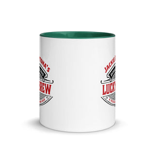 a white coffee mug with a green rim