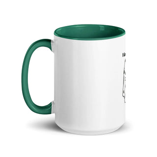 a white and green coffee mug with a green handle