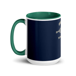 a blue and white coffee mug with a green handle