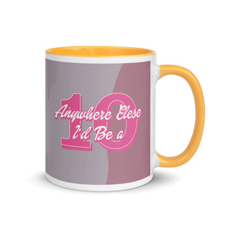 an orange and white coffee mug with a pink and grey background
