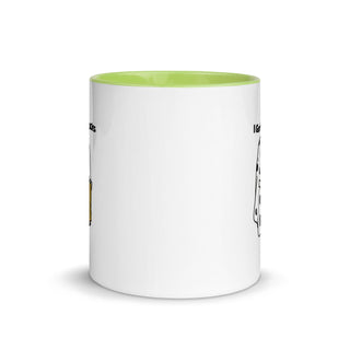 a white and green coffee mug with a yellow rim