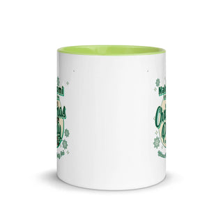 a green and white coffee mug with shamrocks on it