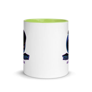 a white coffee mug with a green rim
