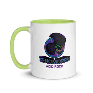 a green and white coffee mug with an image of a dinosaur